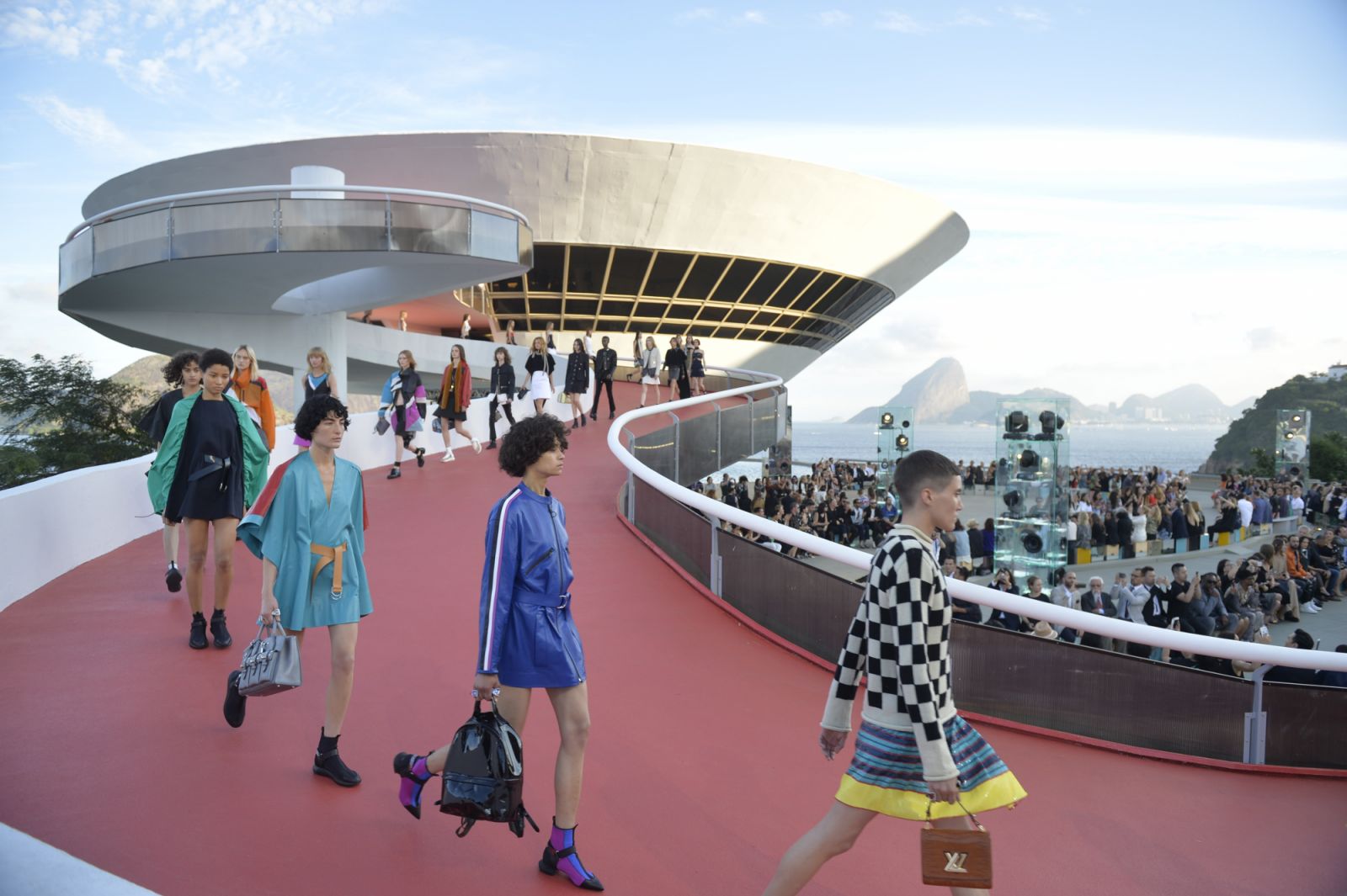 Models descending the curving red-carpeted ramp at the Louis Vuitton Cruise 2017 showcase (Photo: Louis Vuitton)